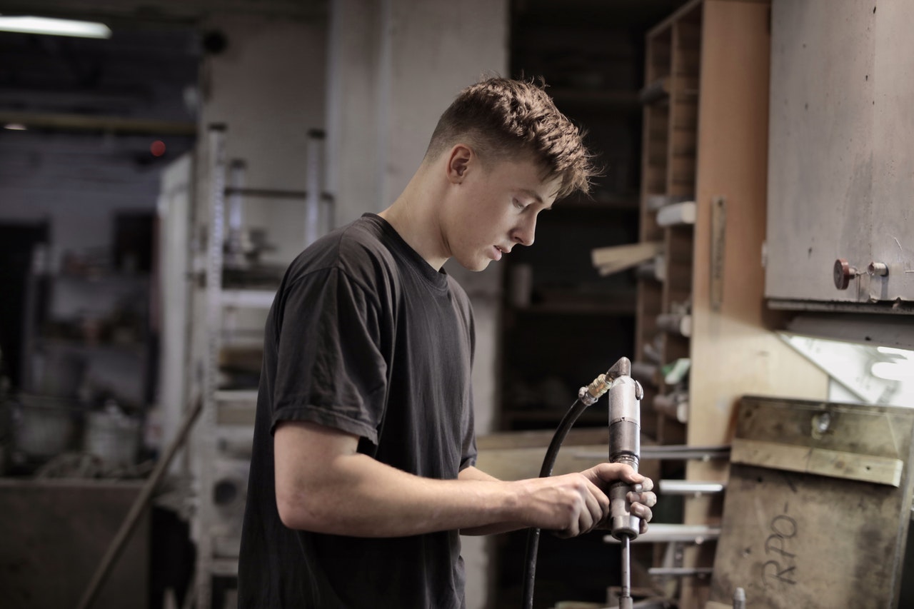 man holding a metal equipment