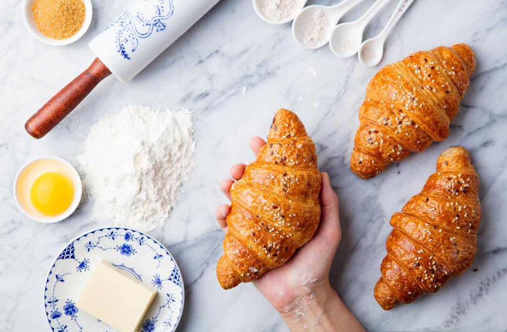 man holding croissant