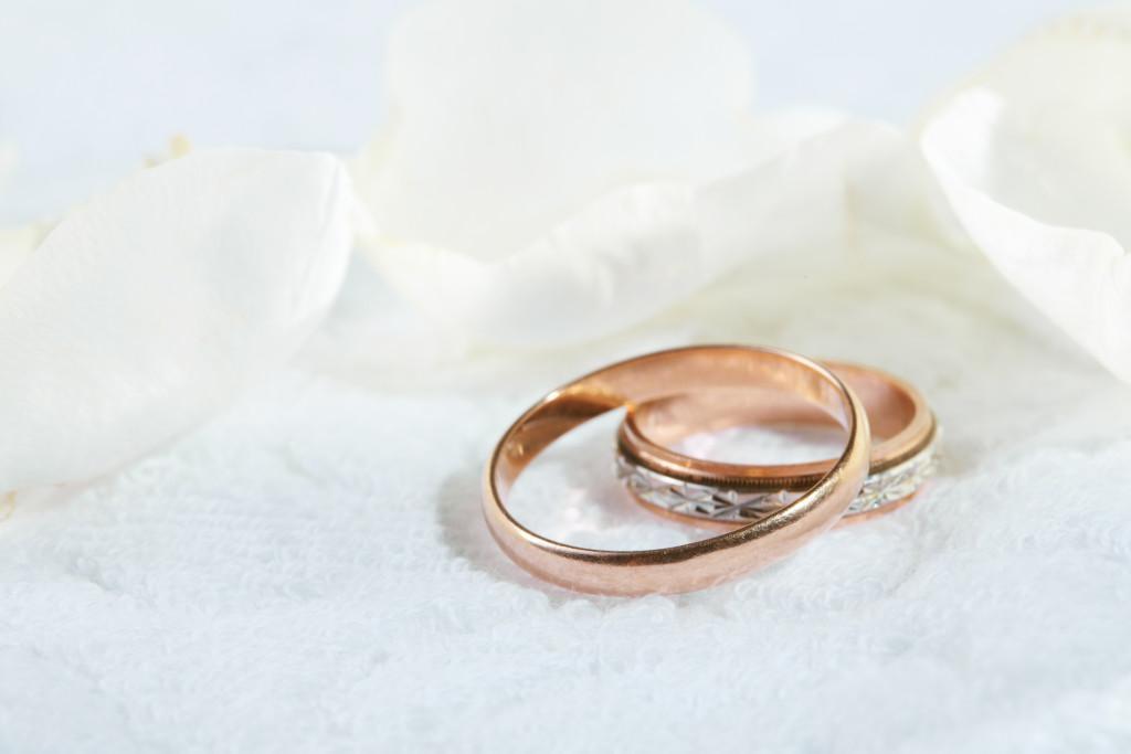 wedding rings situated on top of a white sheet