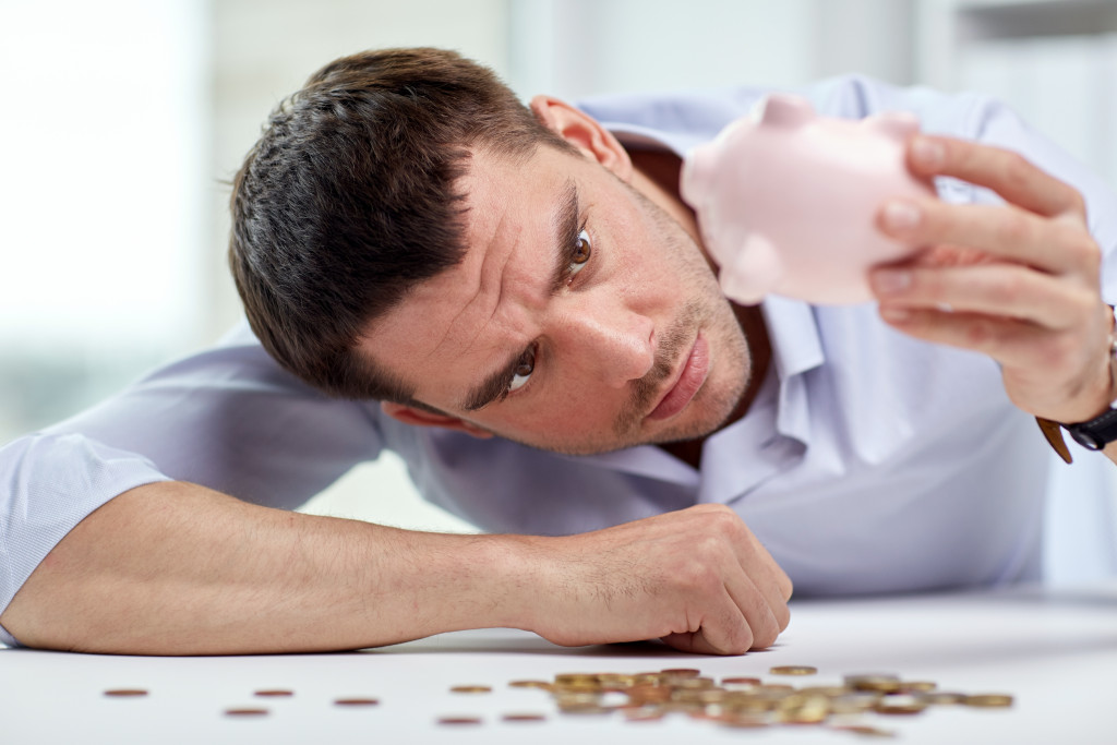 A man checking his piggy bank